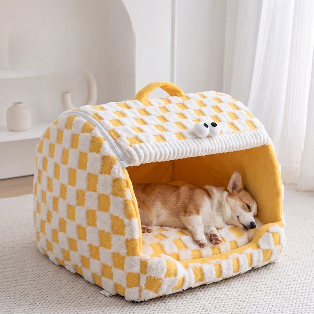 Yellow checkerboard plush pet house with a dog sleeping inside