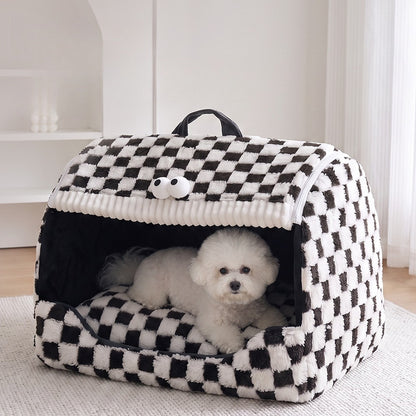 Small white dog resting in the black and white checkerboard pet house