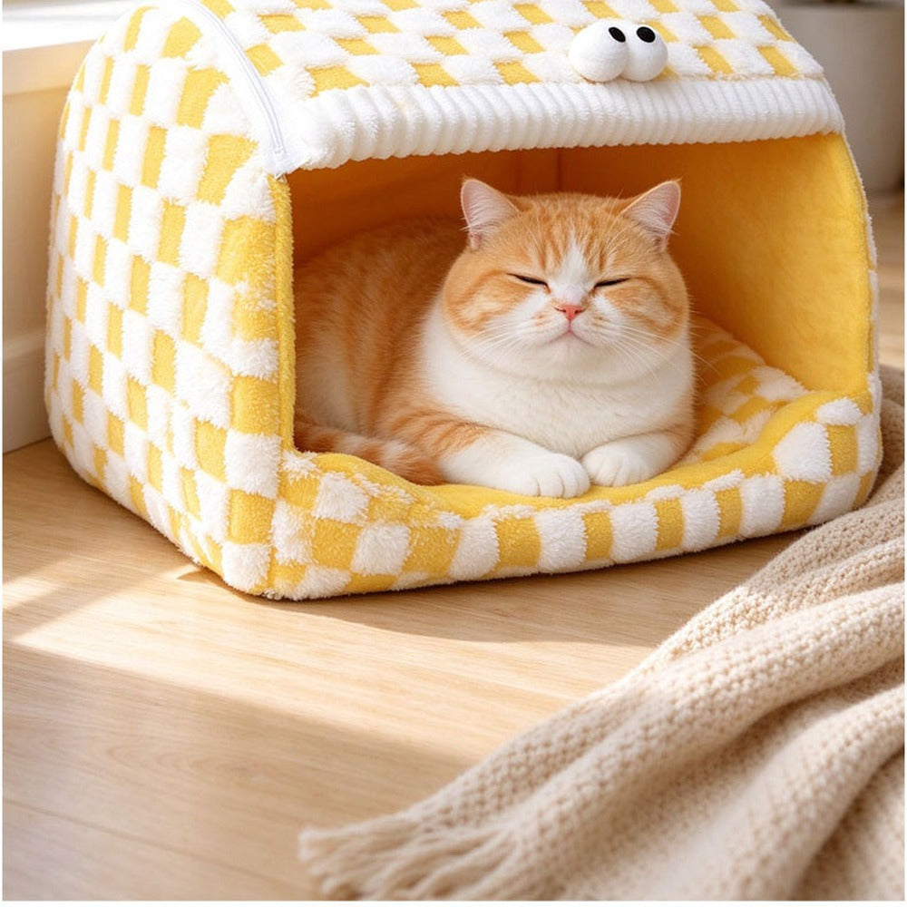 Cat napping inside the yellow checkerboard pet house