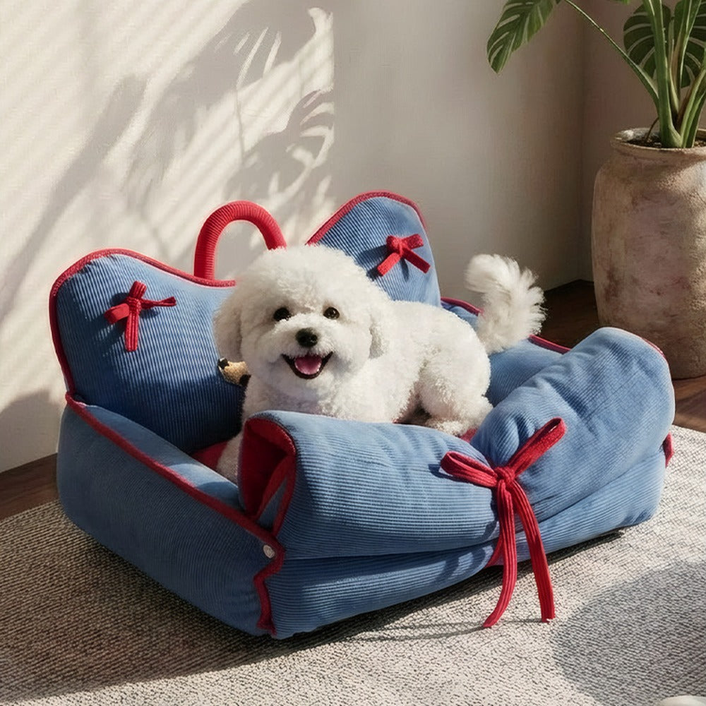 Small dog relaxing in blue corduroy couch bed