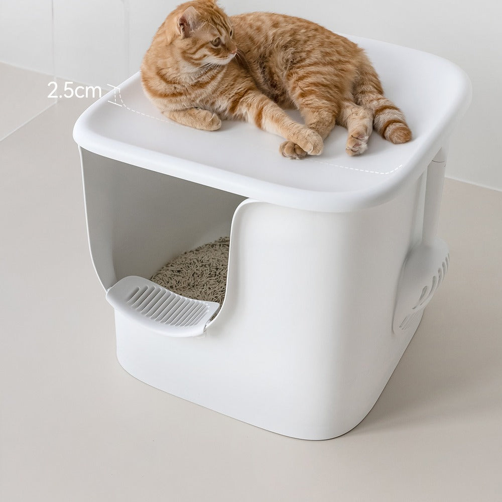 Cat lounging on the lid of an extra large white semi-enclosed litter box