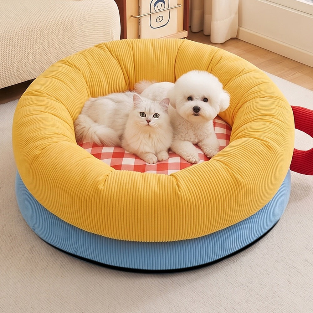 Cat and small dog sharing the XL donut bed