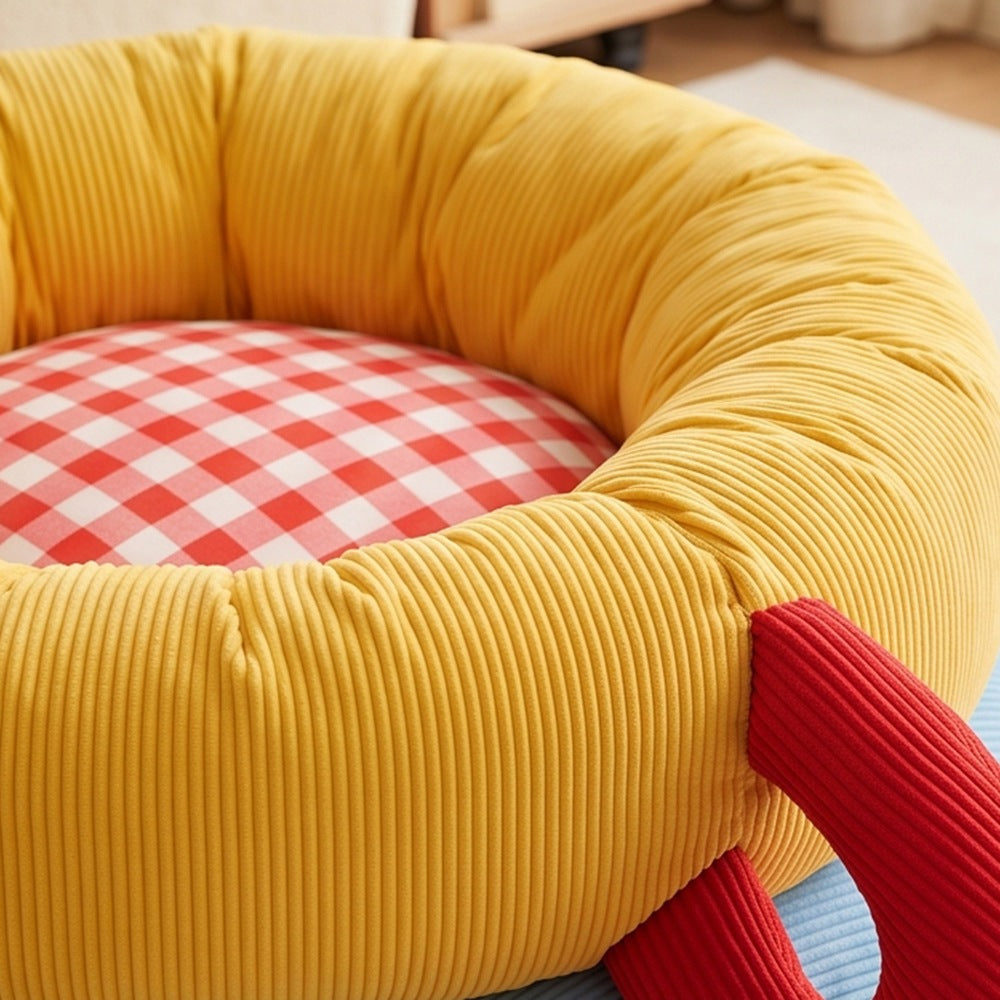 Close-up of corduroy bolster and gingham cushion