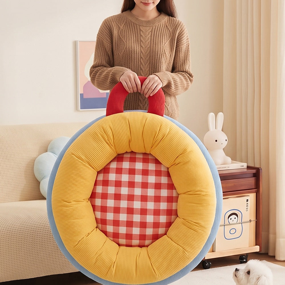 Carrying the donut pet bed by its handle