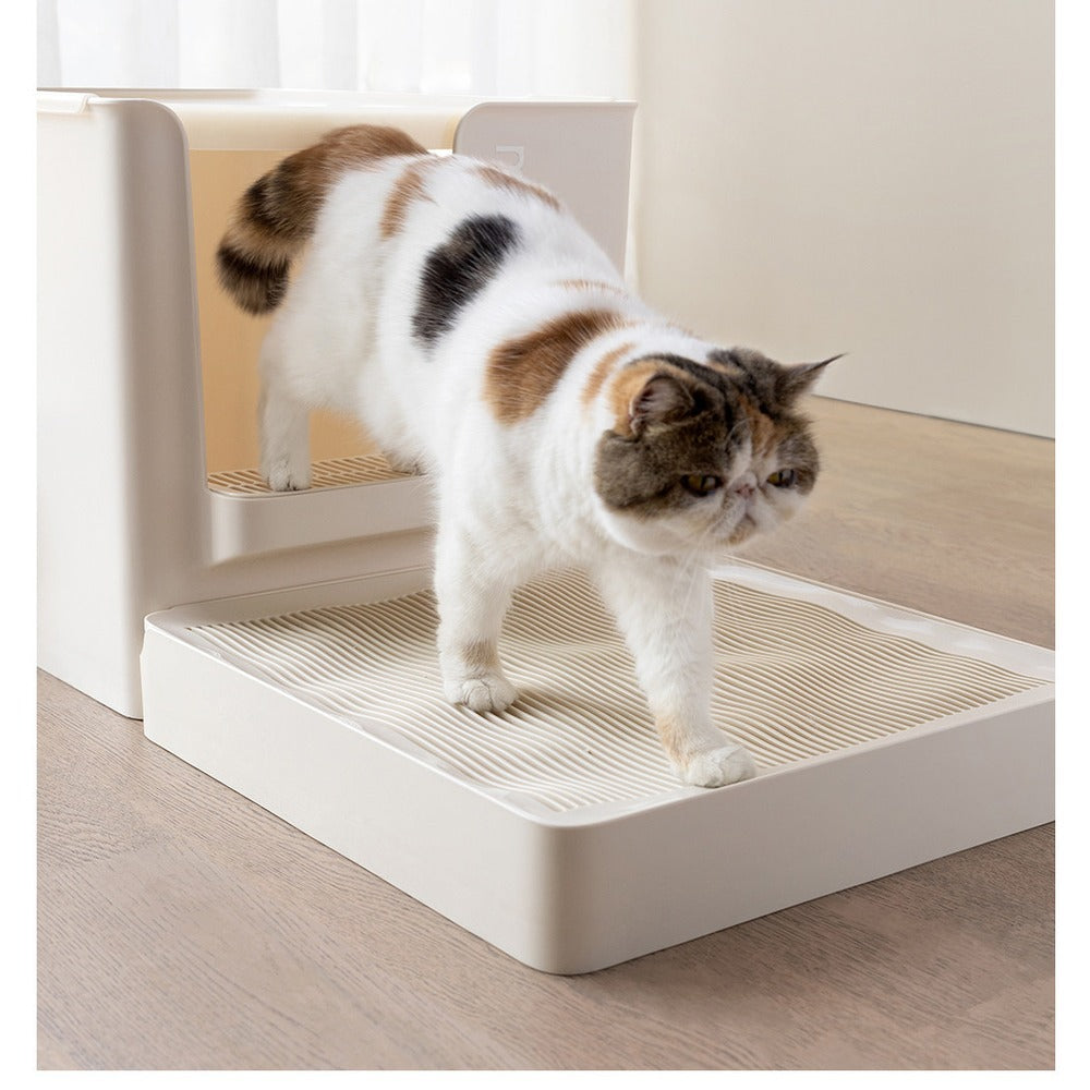 Cat walking across the litter catcher tray