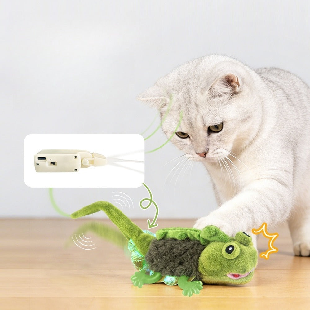 Cat touching the green lizard toy to activate its wiggling tail