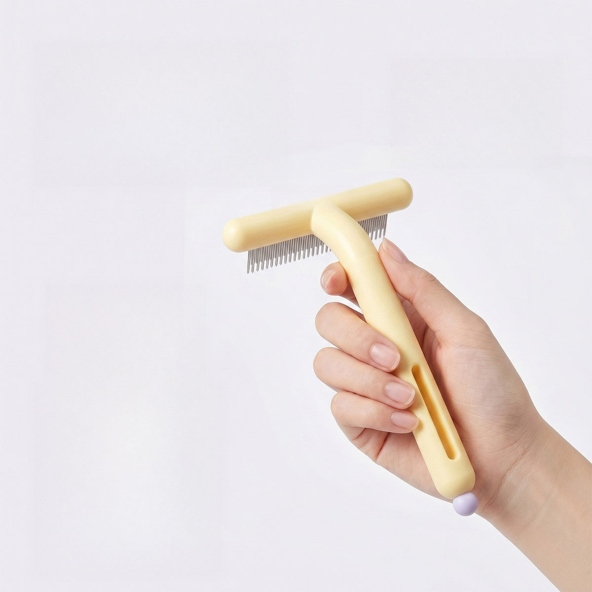 Holding the rake comb by its ergonomic handle